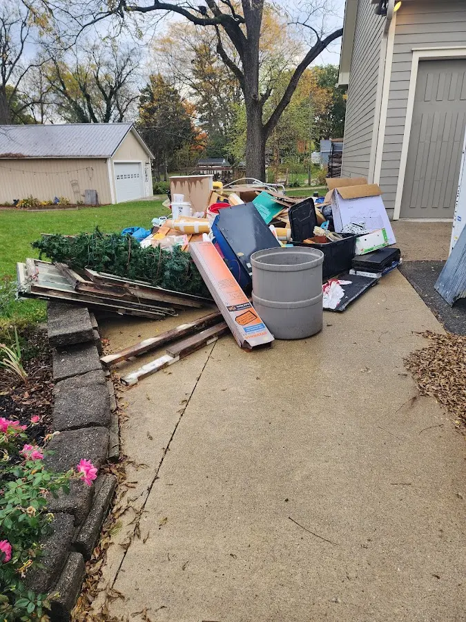 Dumpster being loaded with debris for Roofing Dumpster Rental in Plymouth
